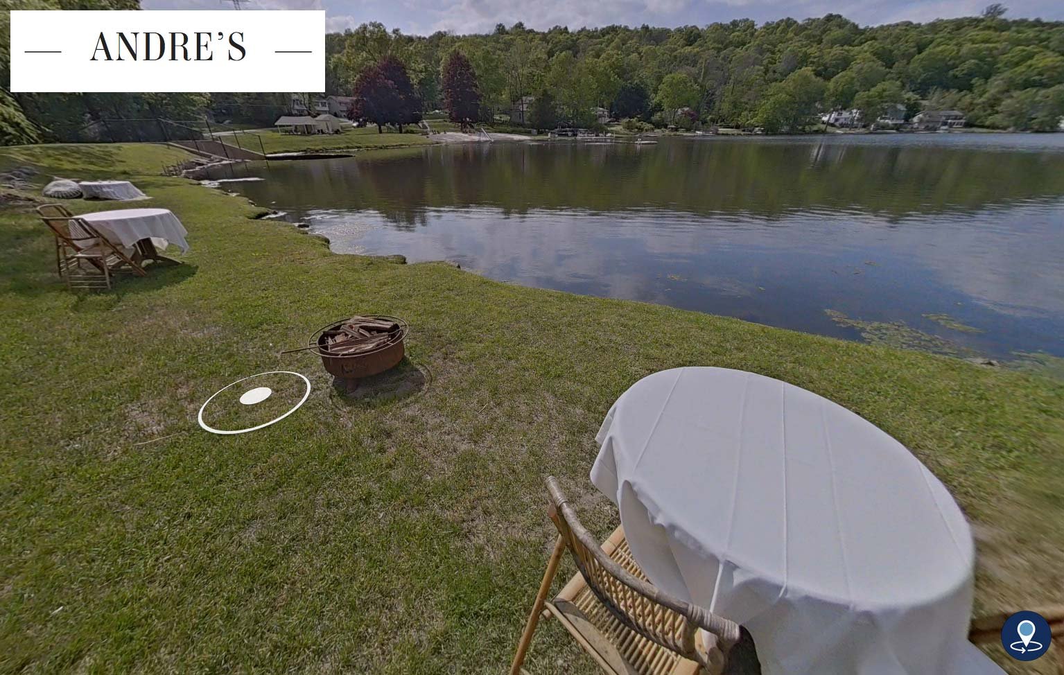 Grab from a virtual tour featuring a small table for two at the edge of a small lake.