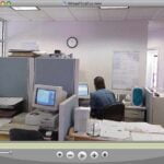 Screen grab of a virtual tour including the office setting of an ad agency with a blue-and-white Macintosh G3 and CRT monitor.