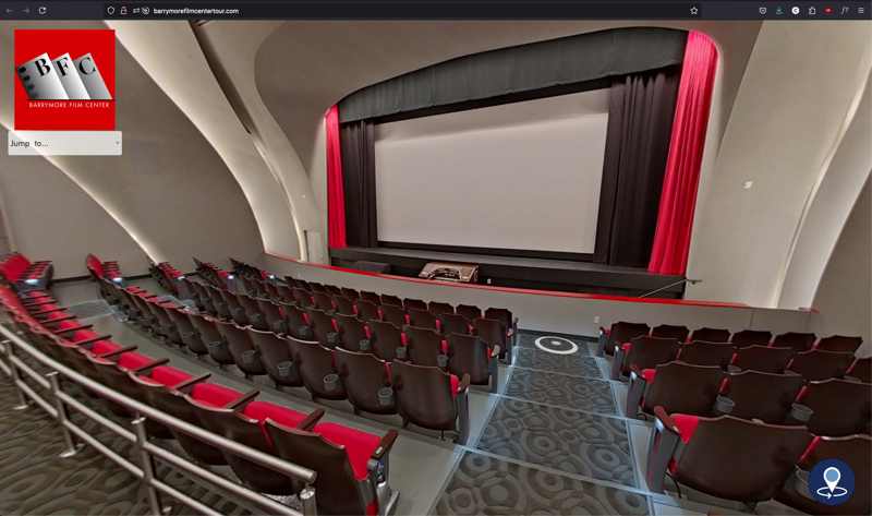 screen grab of a virtual tour from the theater of the barrymore film center with bright red seats and a large movie screen flanked with red curtains.